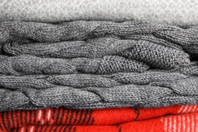 Stack of soft warm plaids as background, closeup