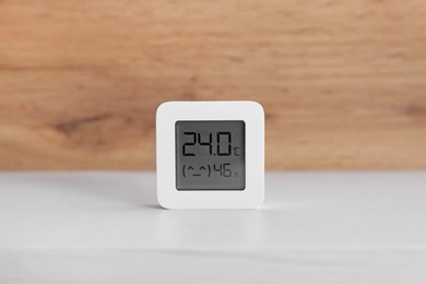 Photo of Digital hygrometer with thermometer on white table