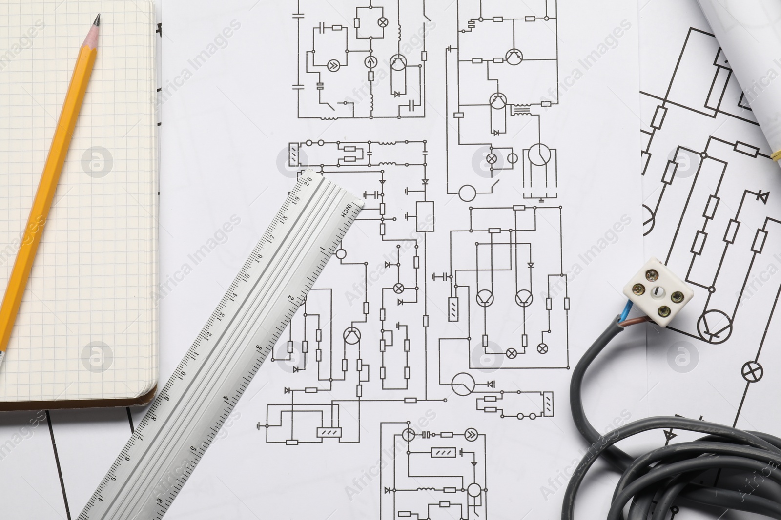 Photo of Wires and office stationery on wiring diagrams, top view