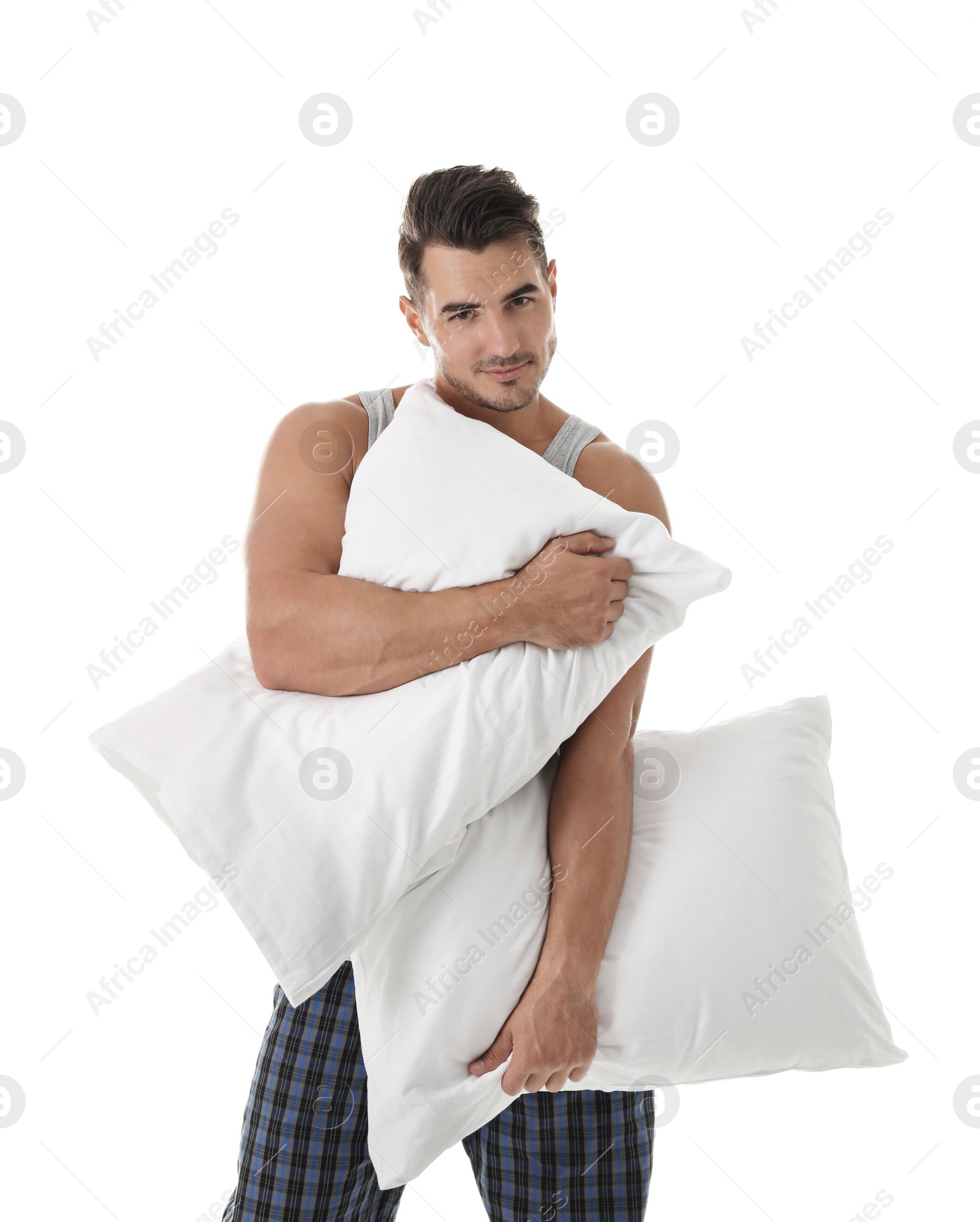 Photo of Young man with soft pillows on white background