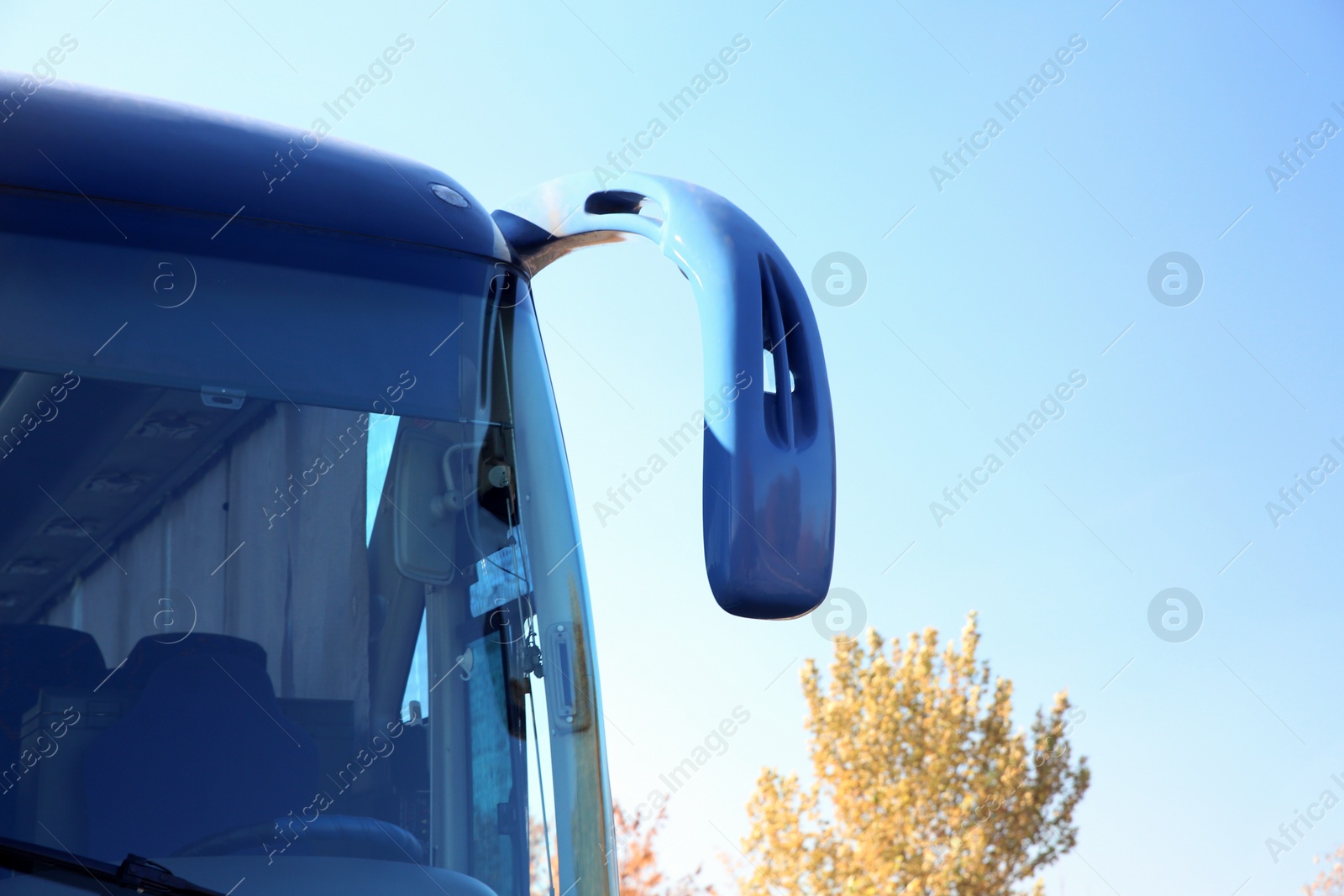 Photo of Modern blue bus against sky. Passenger transportation