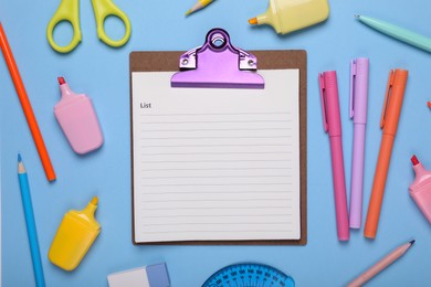 Flat lay composition of clipboard with notes and other school stationery on light blue background, space for text. Back to school