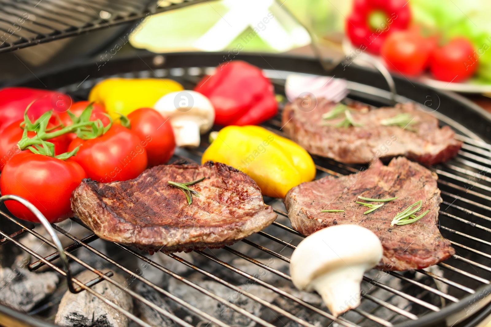 Photo of Modern grill with meat and vegetables outdoors, closeup