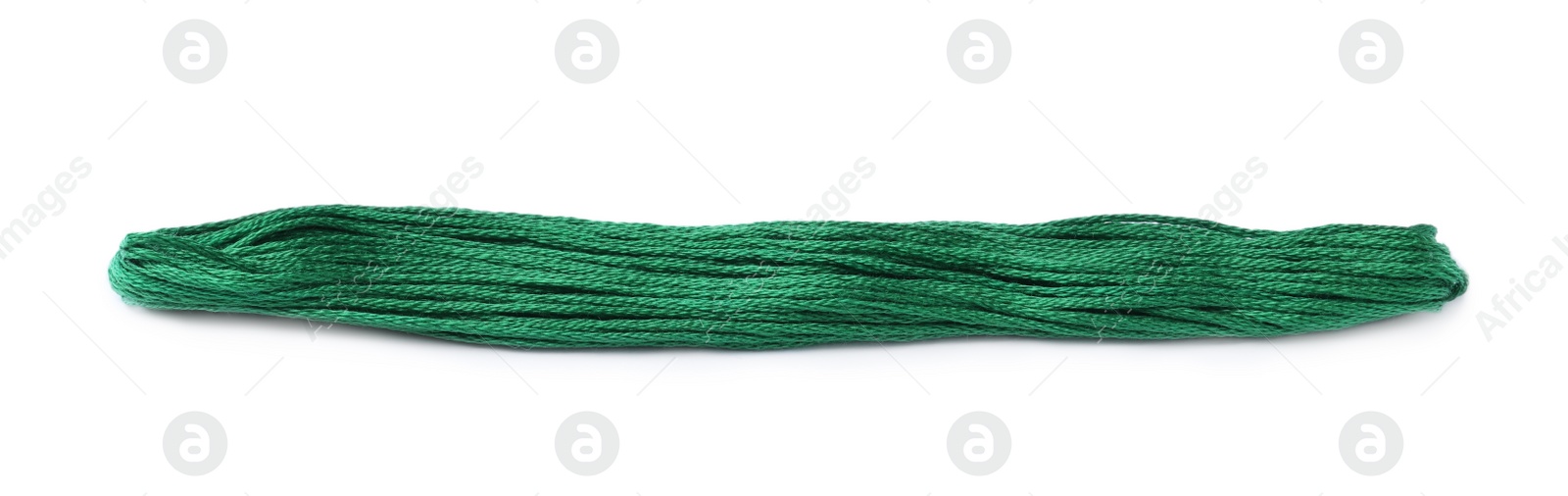 Photo of Bright green embroidery thread on white background