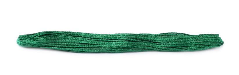 Photo of Bright green embroidery thread on white background