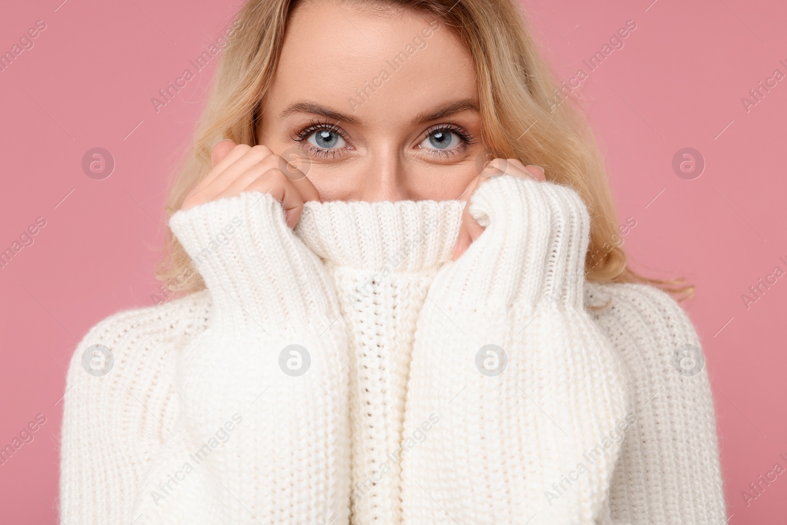 Photo of Beautiful woman in stylish warm sweater on pink background