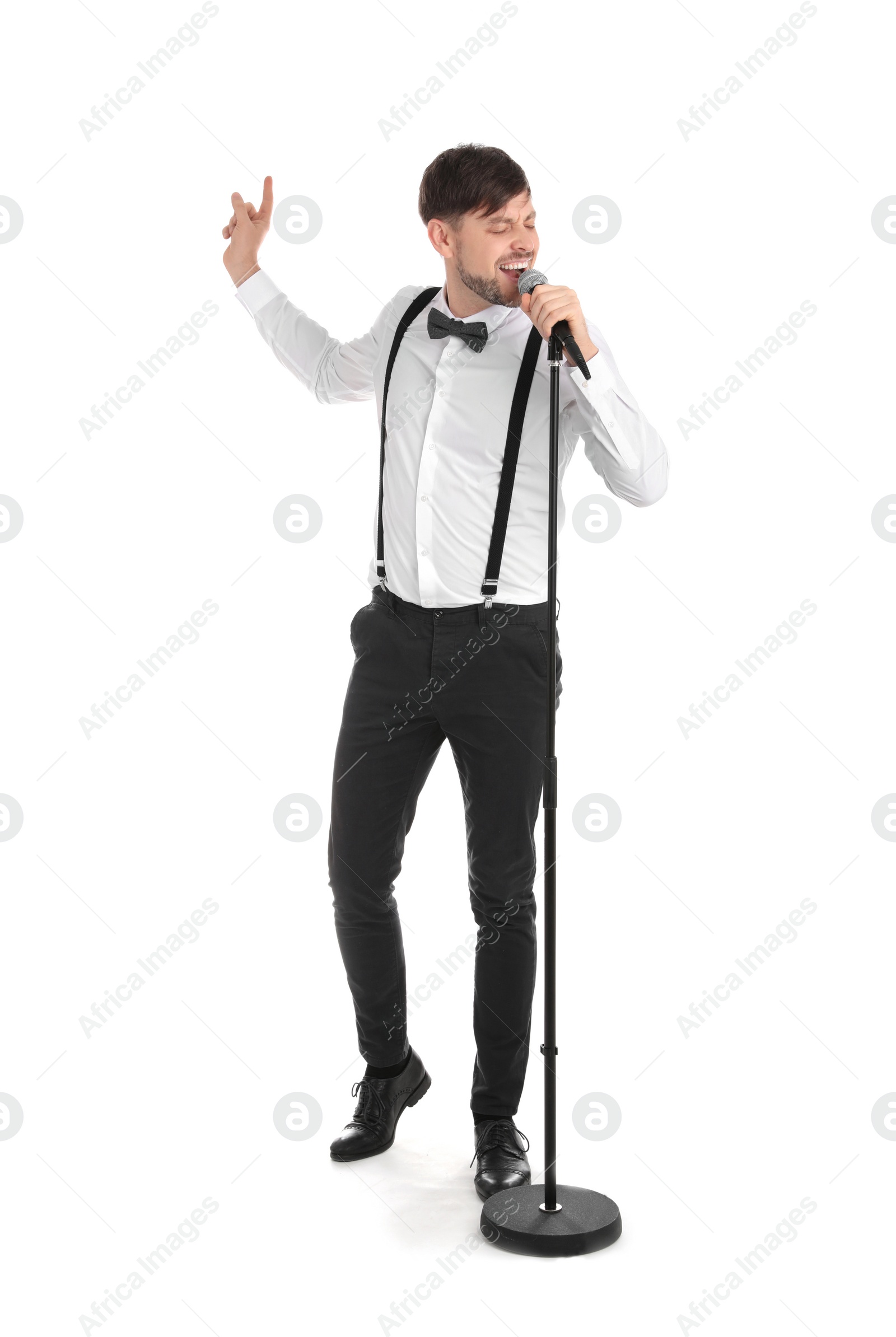 Photo of Handsome man in formal clothes singing with microphone on white background