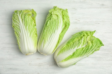 Photo of Fresh ripe cabbages on wooden background, top view