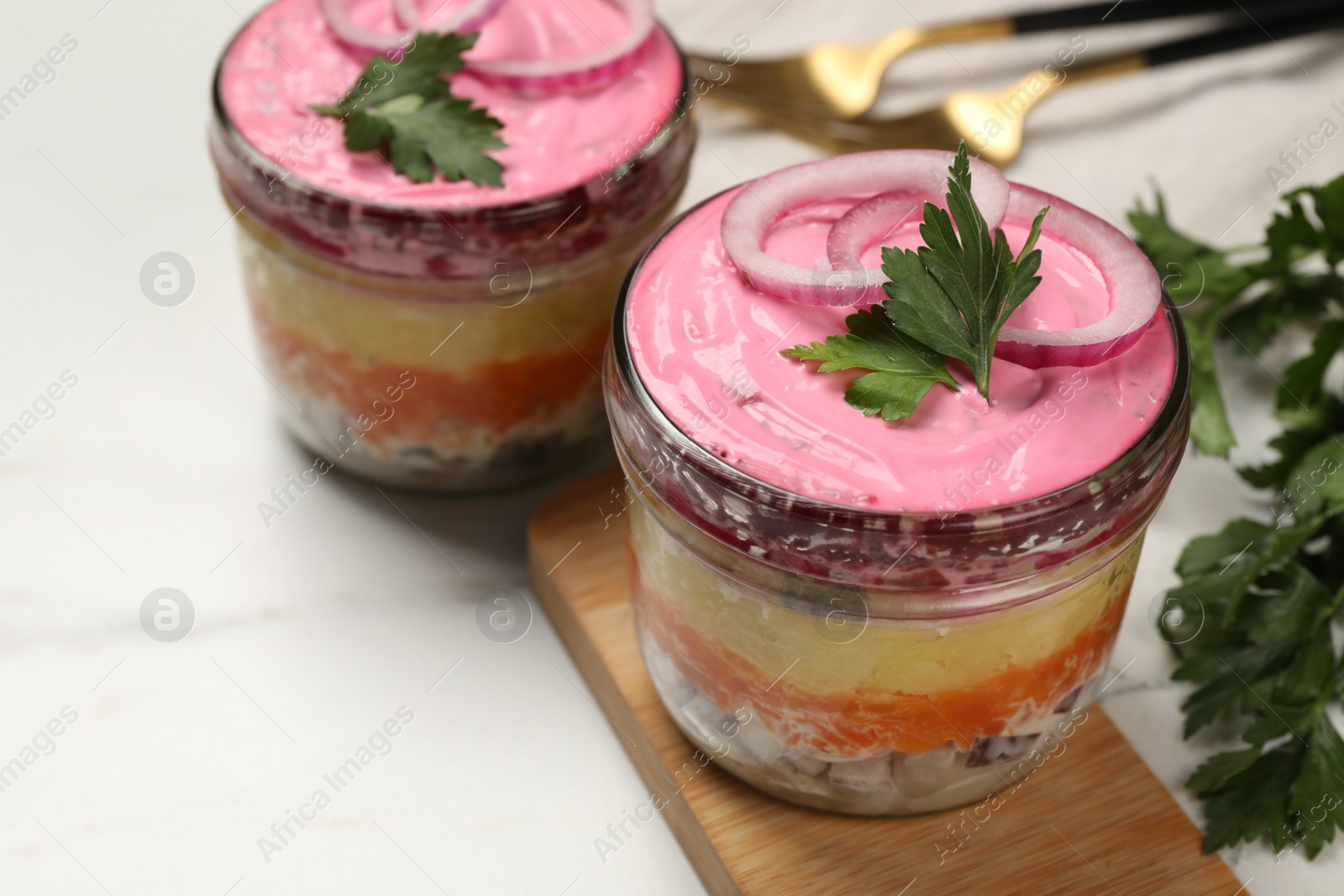 Photo of Herring under fur coat salad on white table, space for text. Traditional Russian dish