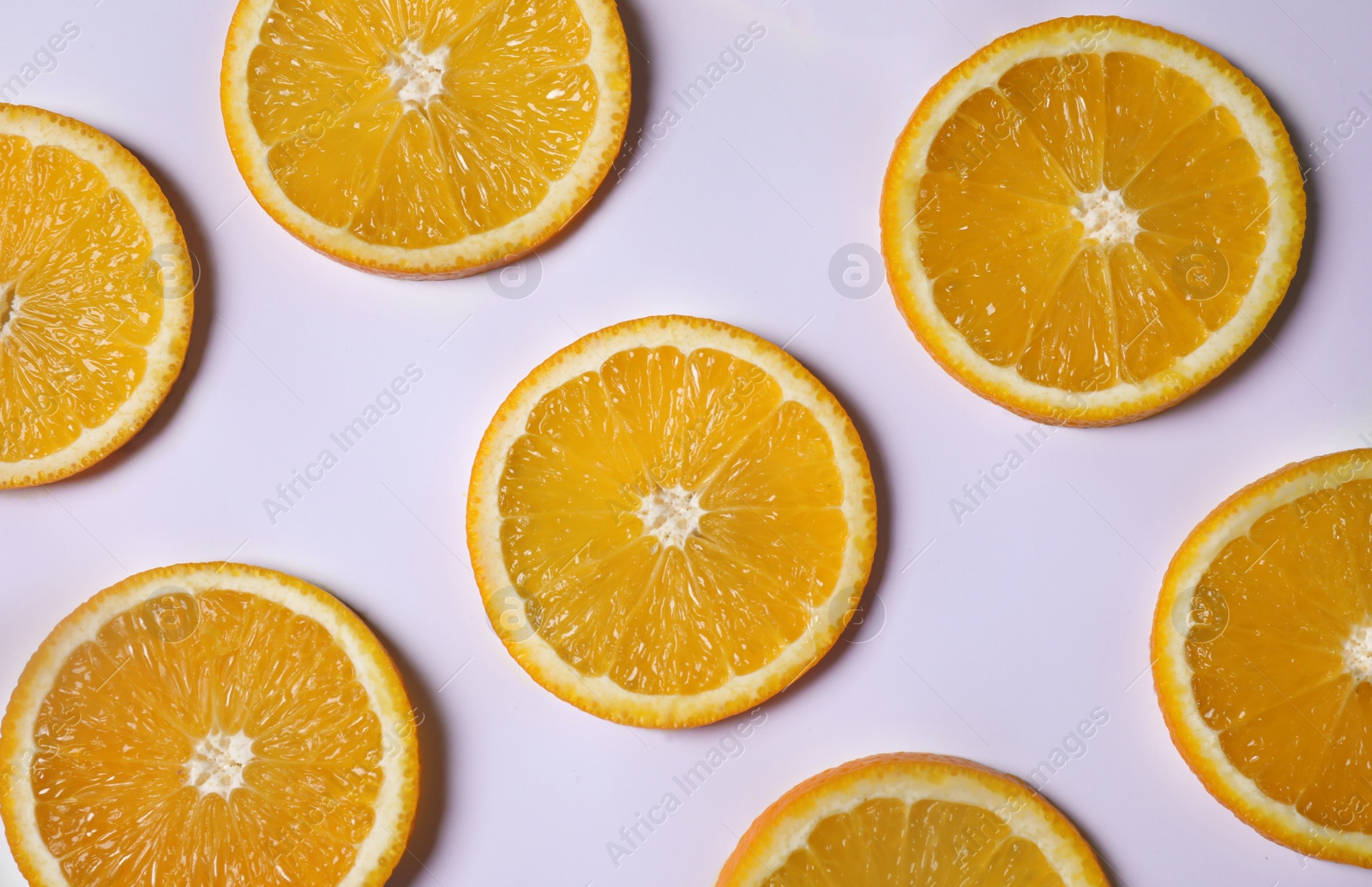 Photo of Fresh orange slices on light background, flat lay