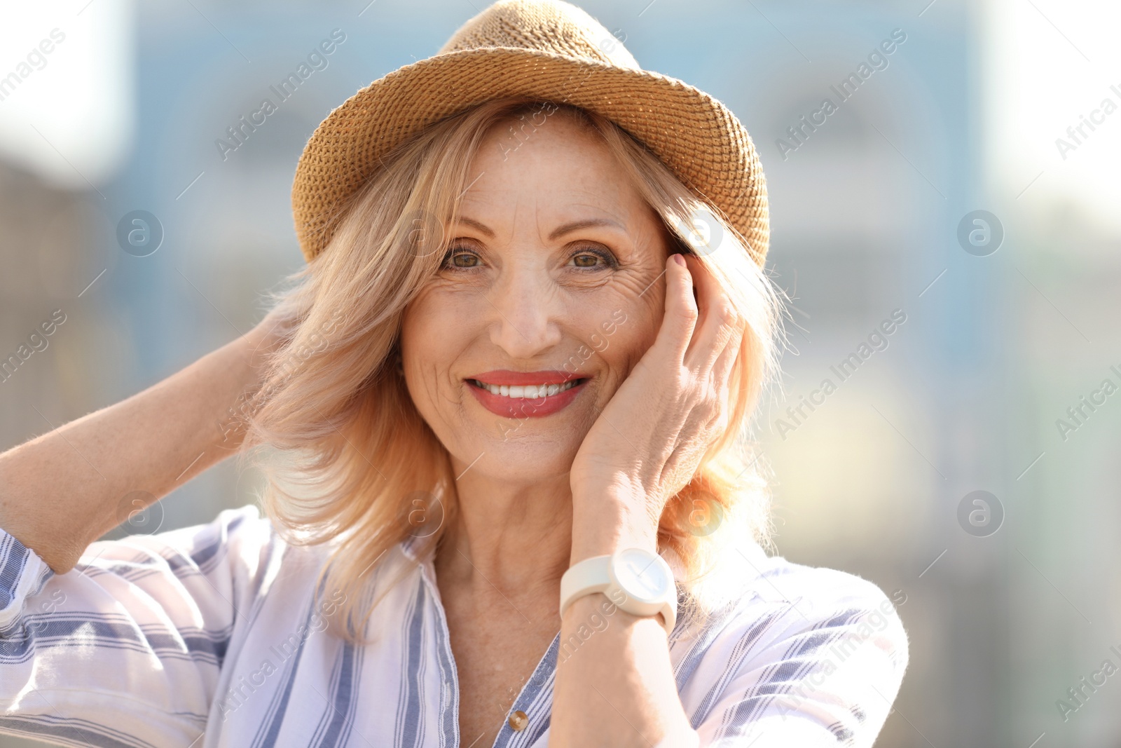 Photo of Portrait of happy mature woman on city street