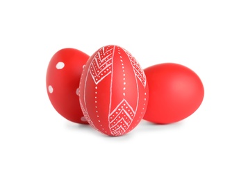 Creative painted red Easter eggs on white background