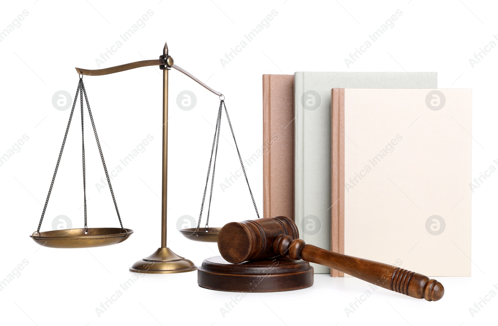 Photo of Wooden gavel, books and scales of justice on white background