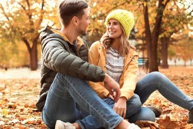 Lovely couple spending time together in park. Autumn walk