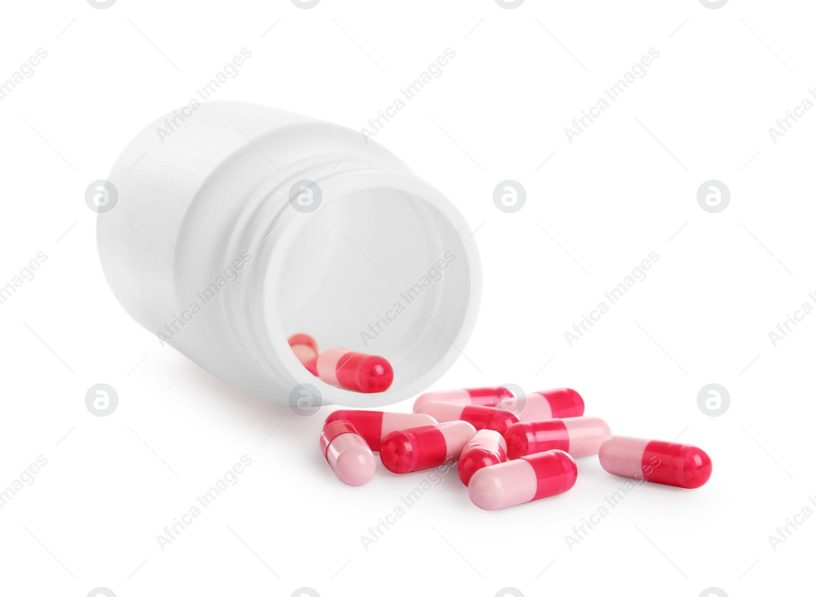 Photo of Medical bottle and pink pills on white background