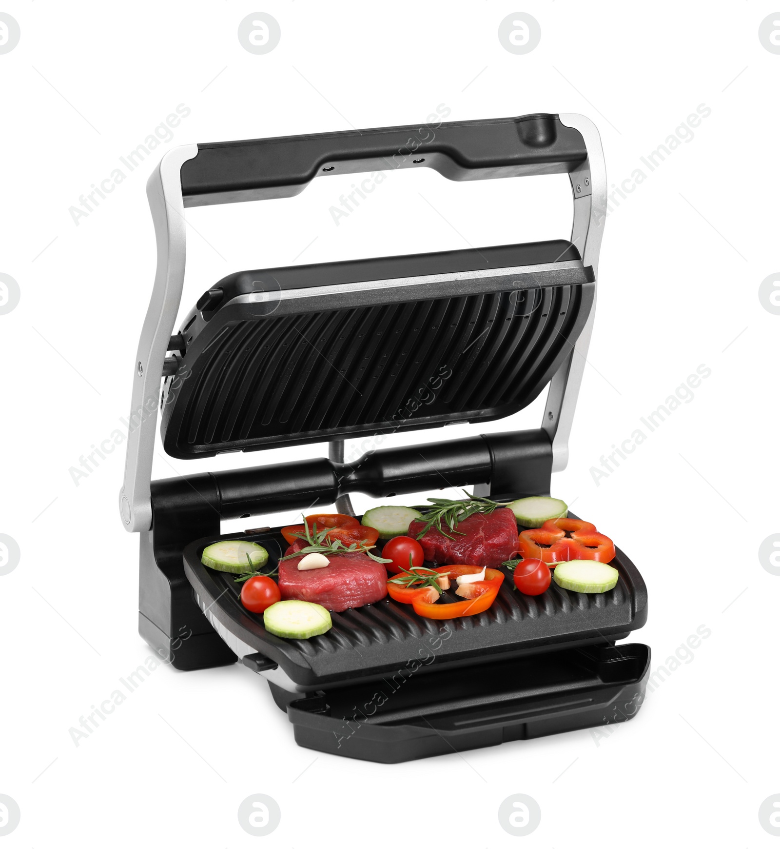 Photo of Electric grill with raw meat, rosemary and vegetables isolated on white