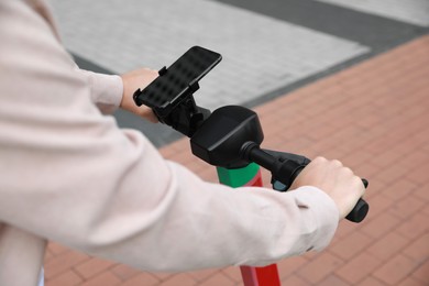 Man riding modern electric kick scooter outdoors, closeup