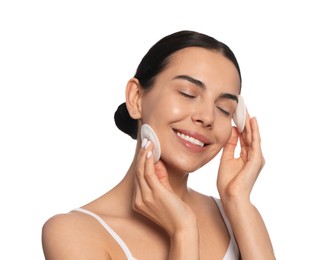 Photo of Young woman using cotton pads with micellar water on white background