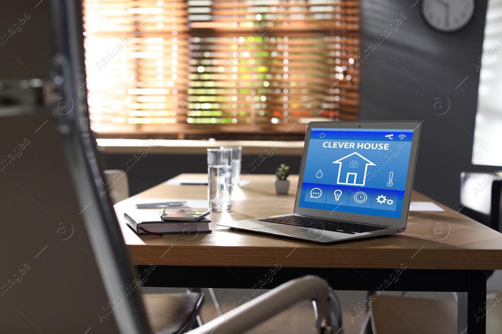 Image of Modern laptop with home security app on table indoors