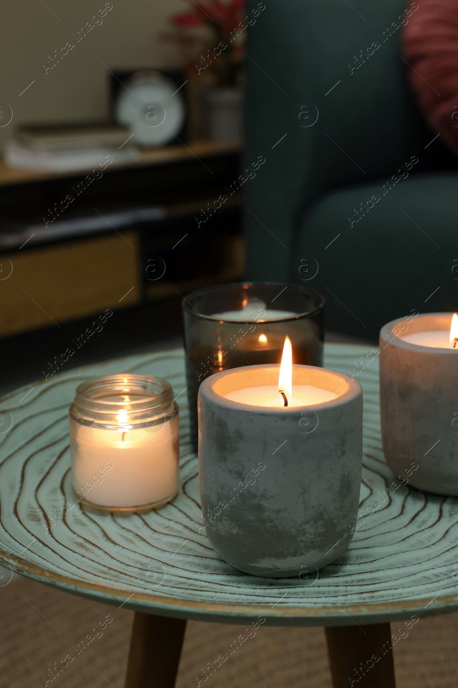Photo of Lit candles on table in living room
