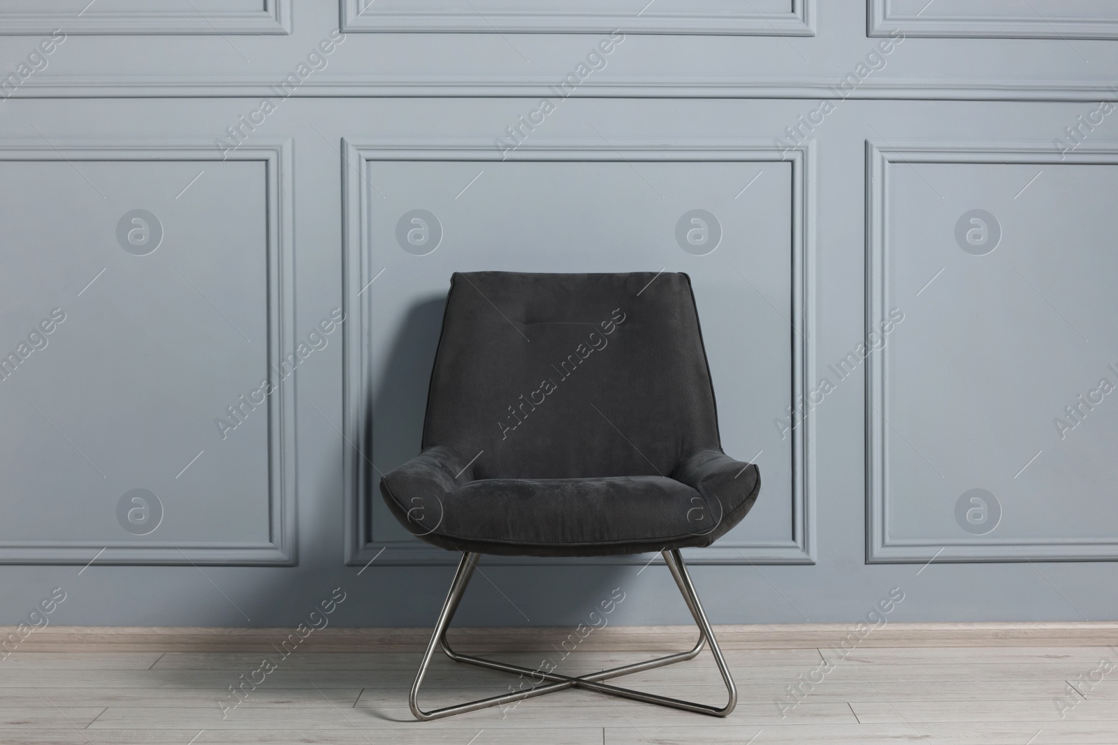 Photo of Comfortable armchair near grey wall in room