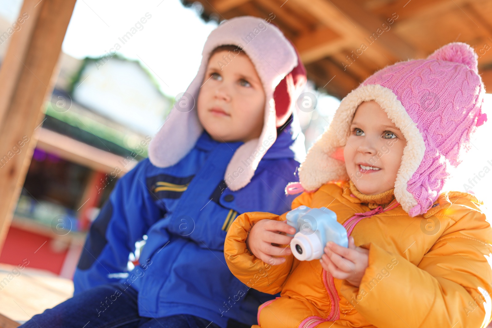 Photo of Cute children with toy camera outdoors. Future photographers