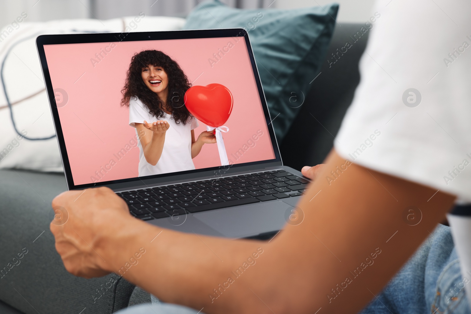 Image of Long distance love. Man having video chat with his girlfriend via laptop at home, closeup