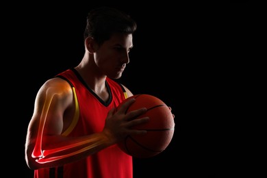 Image of Digital compositehighlighted bones and basketball player with ball on black background