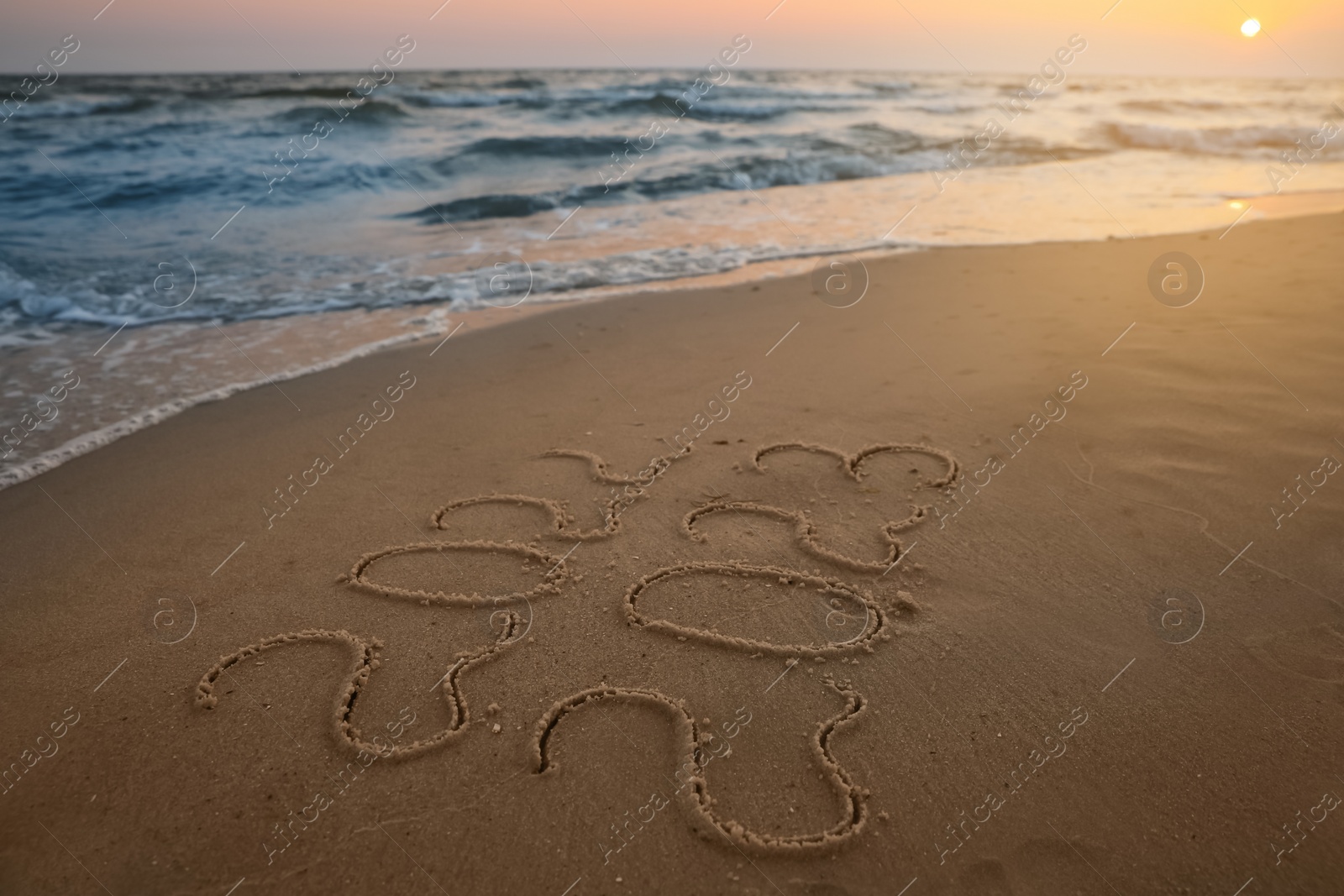 Photo of Sea wave rolling onto sandy beach with written 2022 and 2023. New Year