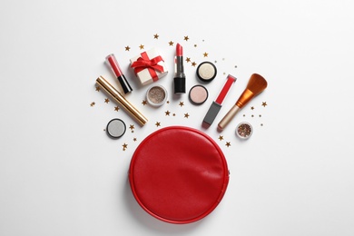 Flat lay composition with makeup products and Christmas decor on white background