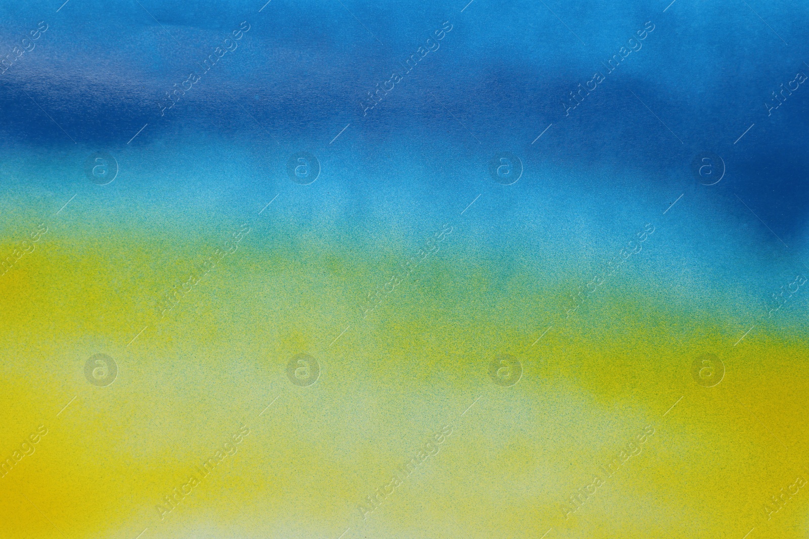 Photo of Abstract picture drawn by blue and yellow spray paints as background, closeup