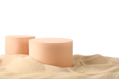 Photo of Presentation of product. Different podiums on sand against white background