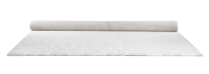 Rolled soft carpet on white background. Interior element