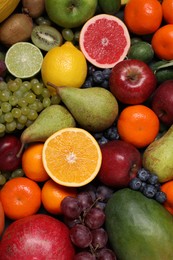 Photo of Different ripe fruits and berries as background, top view