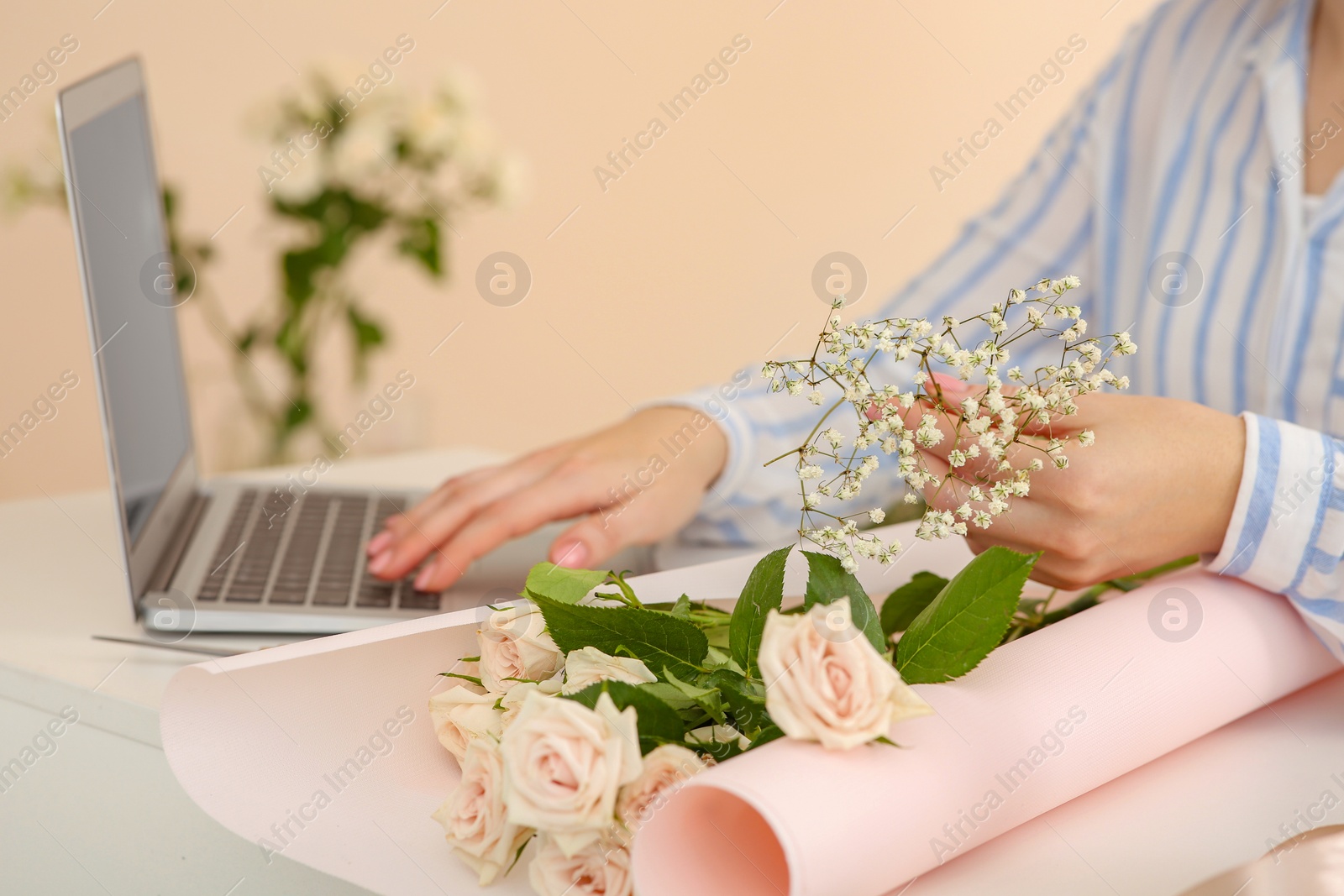 Photo of Woman making bouquet following online florist course at home, closeup. Space for text