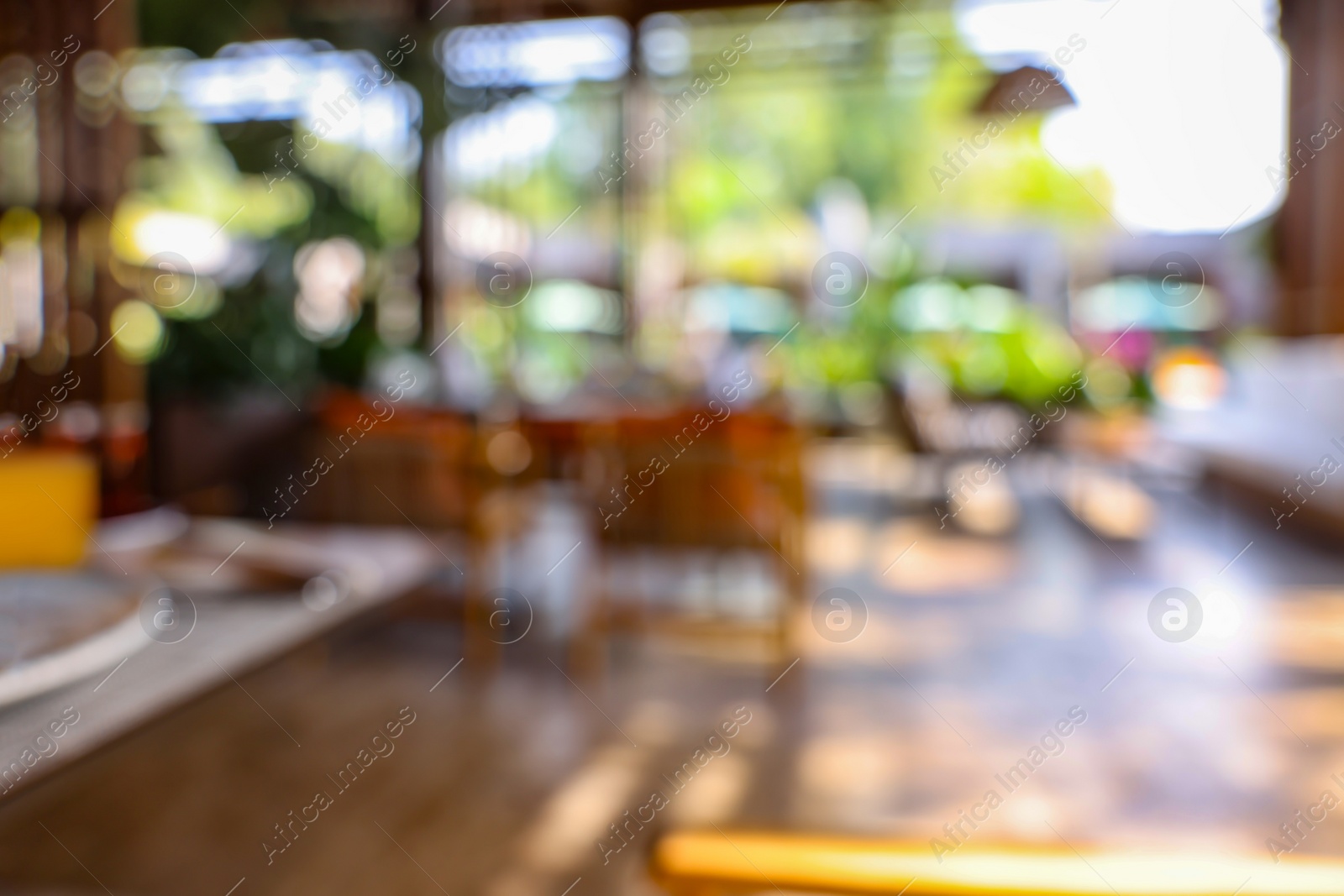 Photo of Blurred view of comfortable cafeteria with furniture