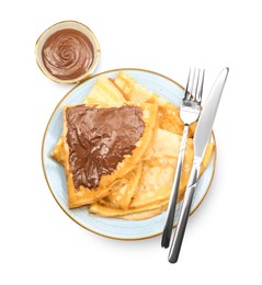 Photo of Tasty crepes with chocolate paste and cutlery isolated on white, top view