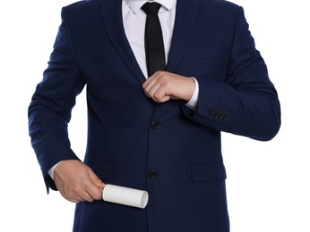 Man cleaning suit with lint roller on white background, closeup