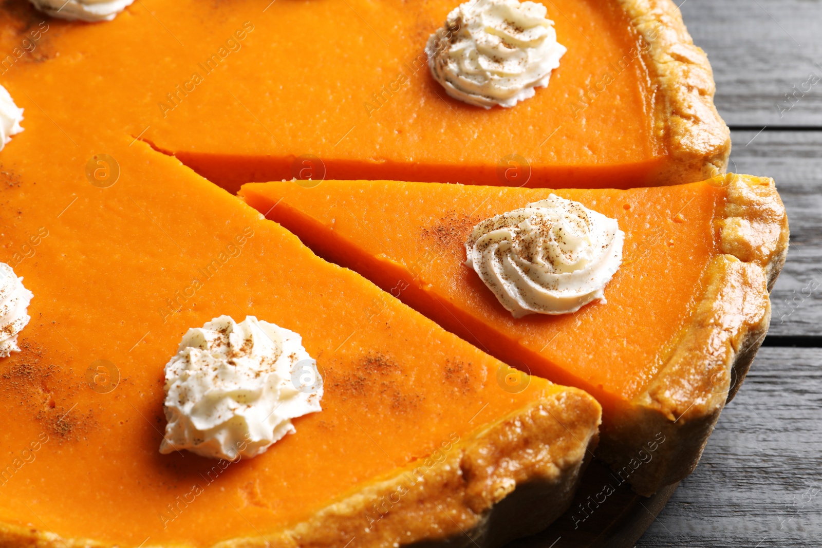 Photo of Fresh delicious homemade pumpkin pie with whipped cream on table, closeup