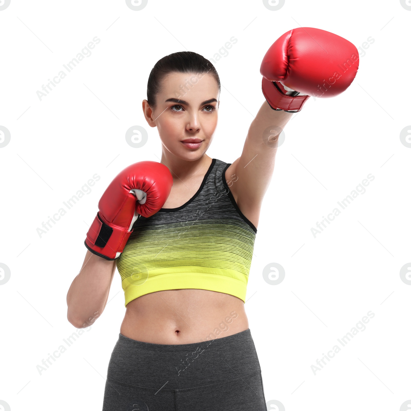 Photo of Beautiful woman in boxing gloves training on white background, low angle view