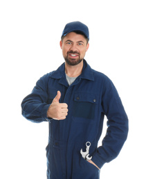 Portrait of professional auto mechanic with wrenches on white background