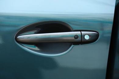 Photo of Closeup view of car door with handle