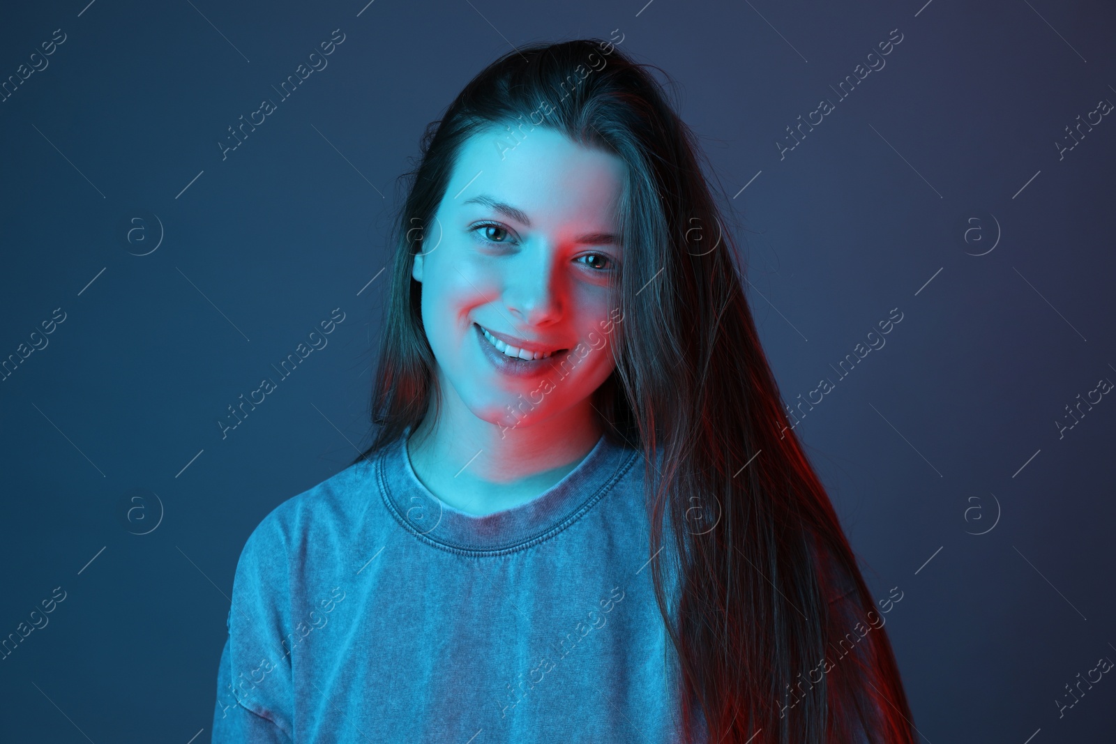 Photo of Portrait of beautiful young woman on color background