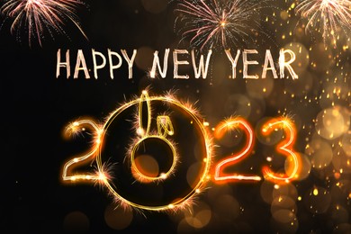 Image of Bright text Happy New 2023 Year made of firework on dark background. Greeting card design