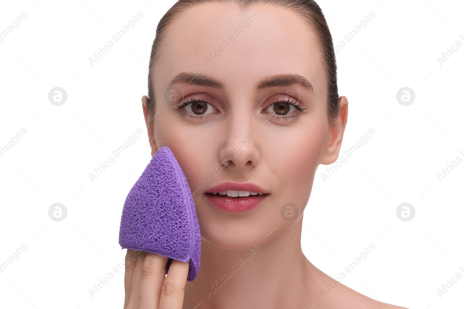 Photo of Happy young woman washing her face with sponge on white background