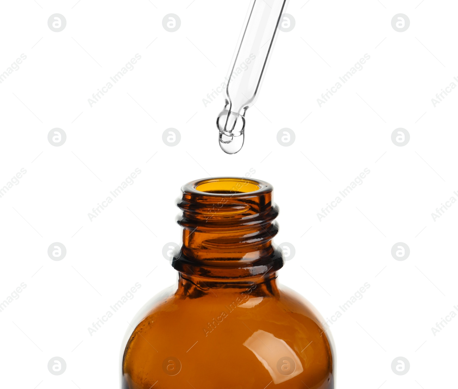 Photo of Pipette with oil over bottle on white background