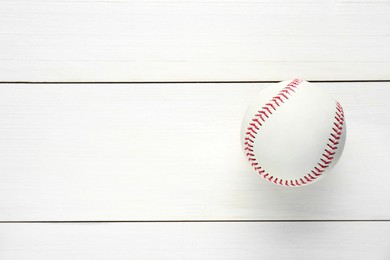 Photo of Baseball ball on white wooden table, top view with space for text. Sports game