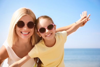 Photo of Mother and daughter at beach. Family vacation