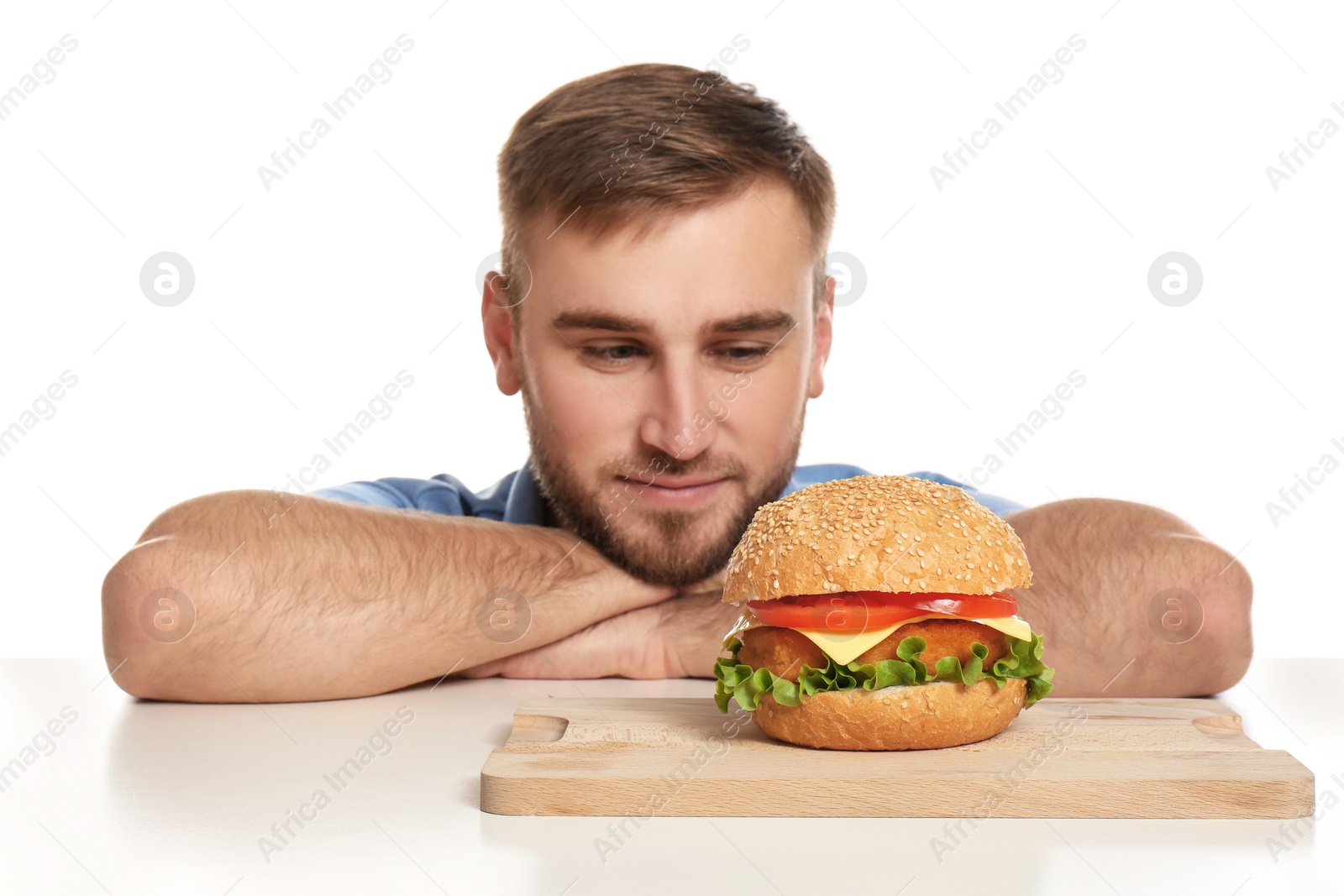 Photo of Young man and tasty burger on white background