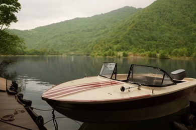 Photo of Beautiful boat on river and mountains in park